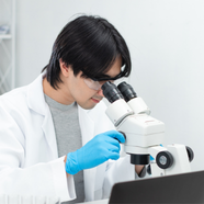Scientist looking into a microscope