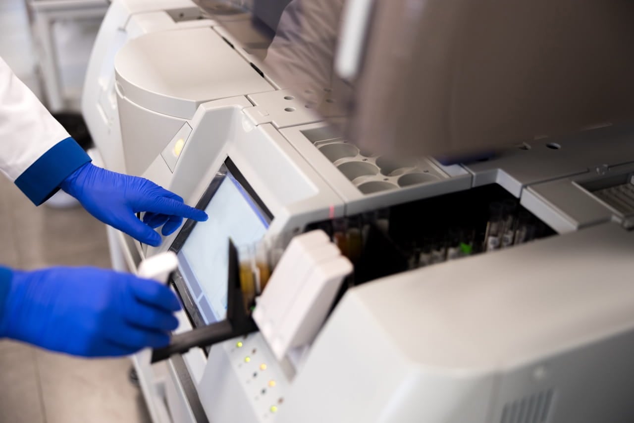 Lab technician operating a machine