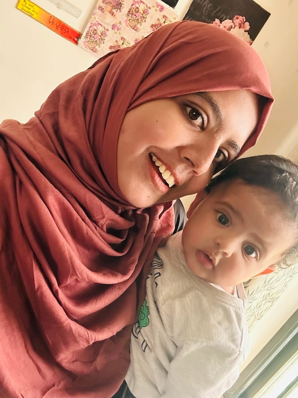 Zuha holding a child